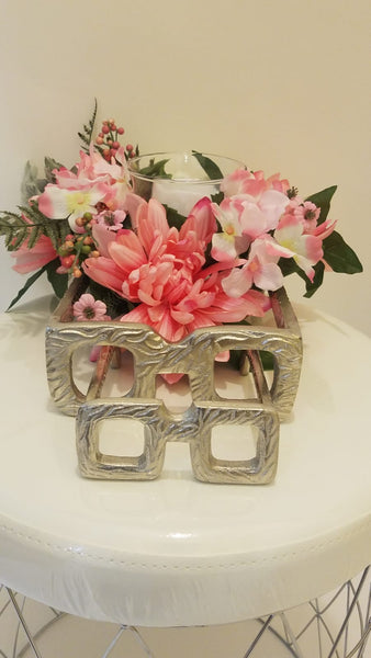 pink floral arrangement with candle holder