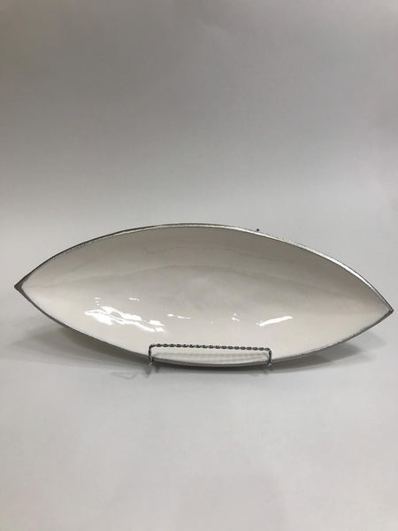 White decorative canoe shaped bowl with silver border