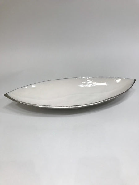 White decorative canoe shaped bowl with silver border