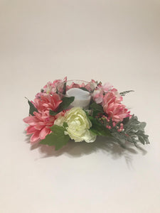 pink floral arrangement with candle holder