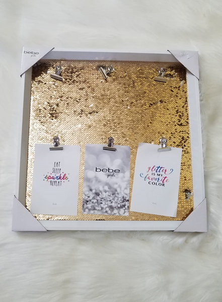 notice board with gold sequins background and silver clips